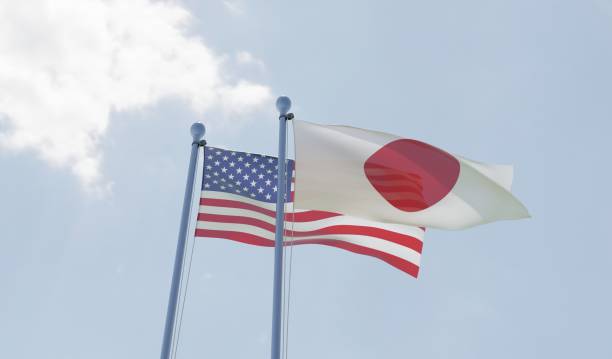 istock USA and Japan, two flags waving against blue sky 1091439046