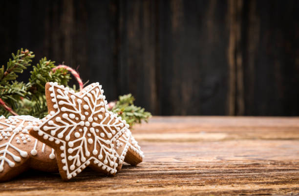 Gingerbread Christmas Star Cookies on wooden background with space on text