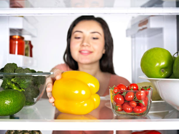 istock Woman taking vegetables from a fridge 1091451266