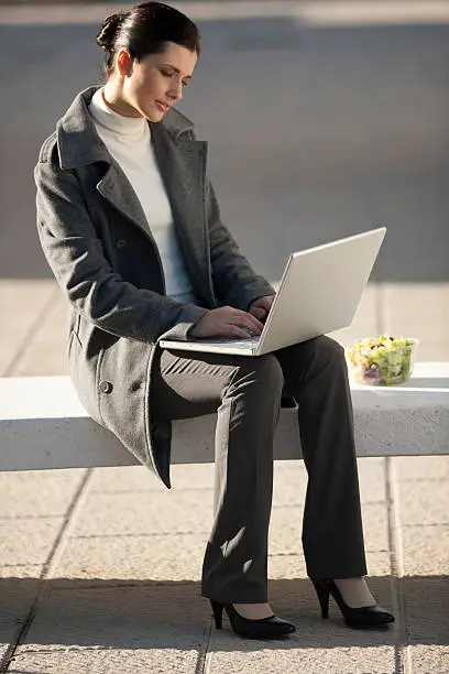 Businesswoman working outdoors during lunch break