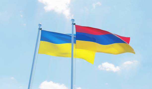 istock Ukraine and Armenia, two flags waving against blue sky 1091456026
