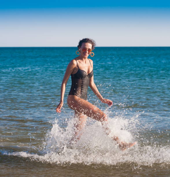 istock Black bikini sea, sunglasses, smile, run 1091458914
