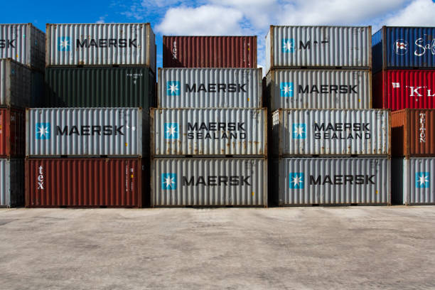 Stacked Maersk Shipping Containers Doncaster, UK - July, 30, 2016.  Stacked container boxes from the shipping company Maersk at a UK freight port representing import and export with copy space. doncaster photos stock pictures, royalty-free photos & images
