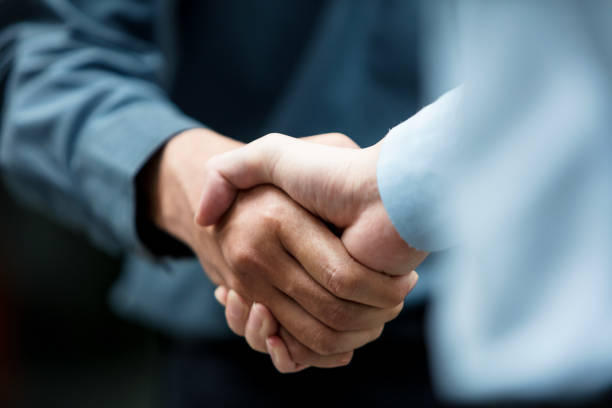 Colleagues shaking hands stock photo