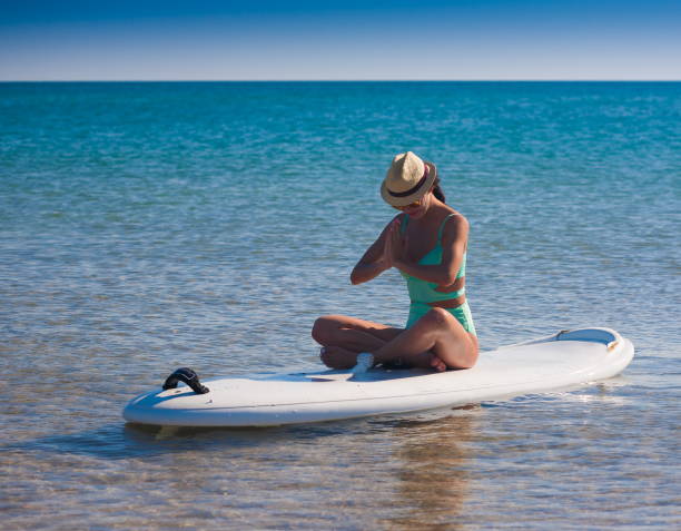 istock Turquoise bikini sea, surfing board, yoga 1091465172