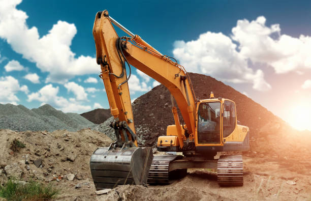 istock Excavator at the construction site, sand, crushed stone, against the blue sky background. Construction equipment, construction. 1091465380