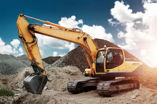 istock Excavator at the construction site, sand, crushed stone, against the blue sky background. Construction equipment, construction. 1091465390