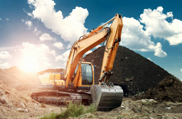 istock Excavator at the construction site, sand, crushed stone, against the blue sky background. Construction equipment, construction. 1091465400