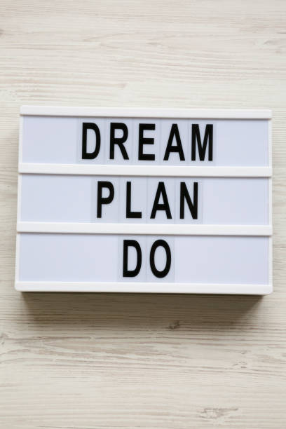 istock Modern board with text 'Dream plan do' over white wooden background, top view. From above, flat lay, overhead. 1091469246