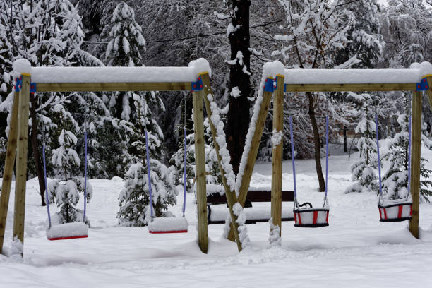 istock Swing covered by snow in a playground 1091474720