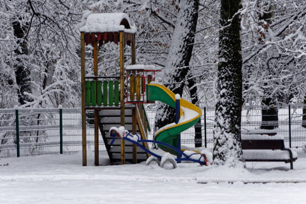 istock Slide covered by snow in a playground 1091474734