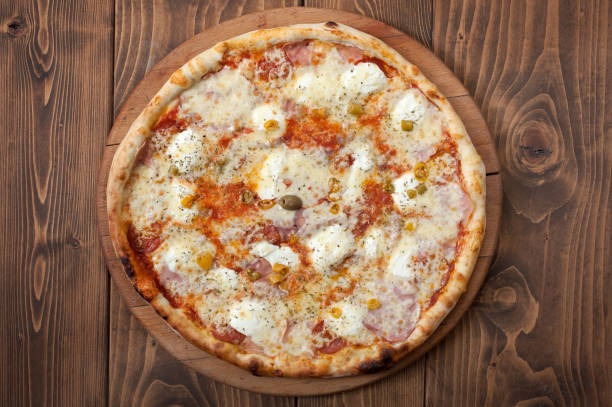 istock Pizza margherita on wooden background, top view 1091474978