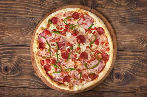istock Pizza pepperoni with tomatoes, bacon and olives, side view 1091475118
