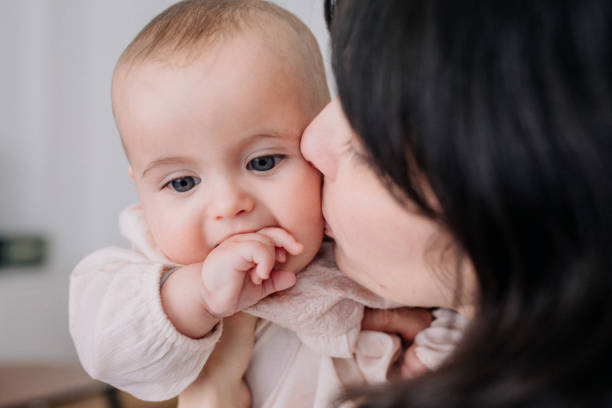 istock Mother cuddling with her baby daughter 1091478382
