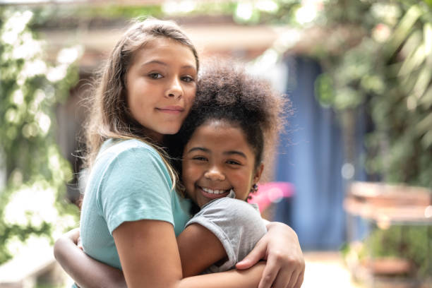 istock Girls embracing at home 1091479870
