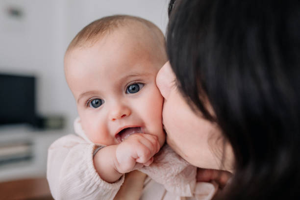 istock Mother cuddling with her baby daughter 1091480890