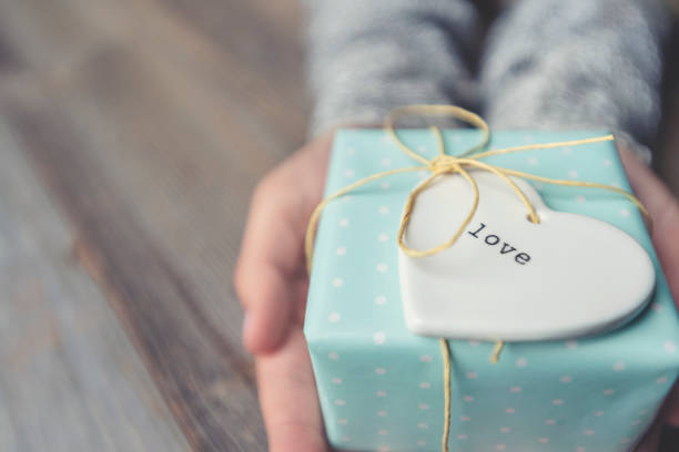 istock Rustic gift box on a wooden table tied with a bow. 1091482020