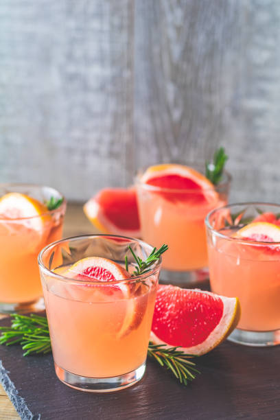 istock Fresh pink alcoholic cocktail with grapefruit, ice and rosemary 1091482876