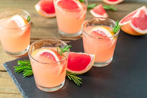 istock Fresh pink alcoholic cocktail with grapefruit, ice and rosemary 1091482882