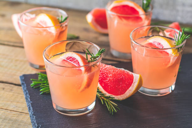 istock Fresh pink alcoholic cocktail with grapefruit, ice and rosemary 1091482884