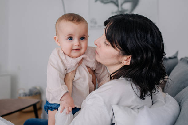 istock Mother cuddling with her baby daughter 1091483250