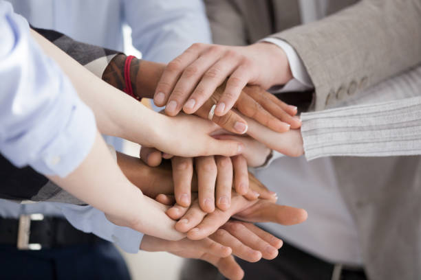 istock Close up of diverse people put hands in stack 1091483404