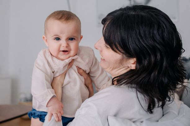 istock Mother cuddling with her baby daughter 1091485248