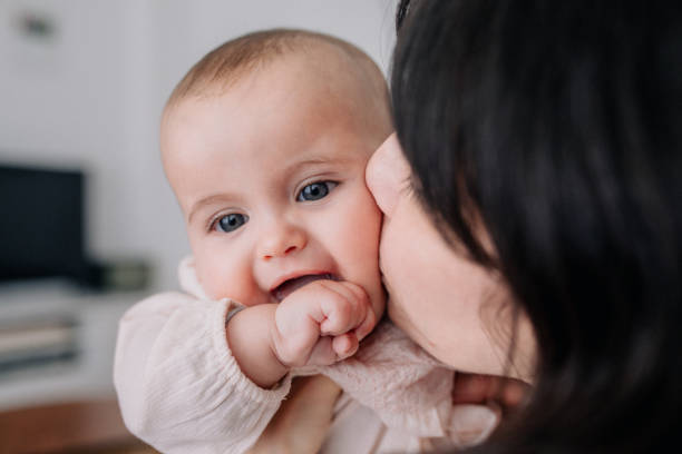 istock Mother cuddling with her baby daughter 1091485772