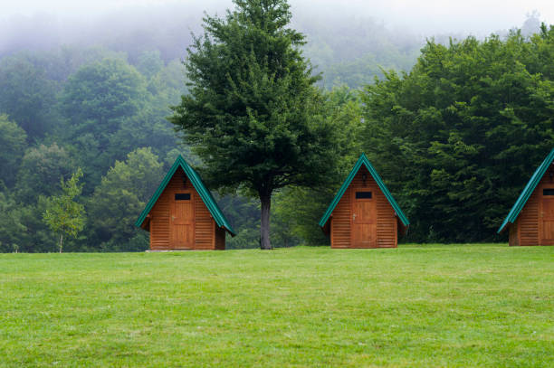 istock Traditional camping cabins on the lawn near mountain 1091487628