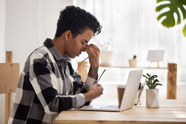 istock Tired black girl massage nose bridge suffering from headache 1091488720