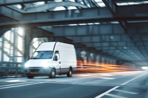 istock Van driving on a road through an industrial style bridge 1091488794