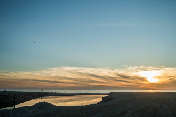 istock Moody sunset over Santa Monica beach with reflection off water 1091489616