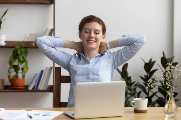 istock Lazy female sitting at office desk looking at computer screen 1091491624