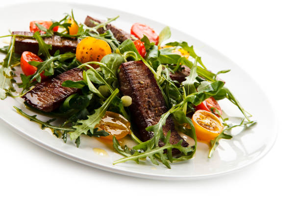 istock Grilled beef steak and vegetables on white background 1091492256