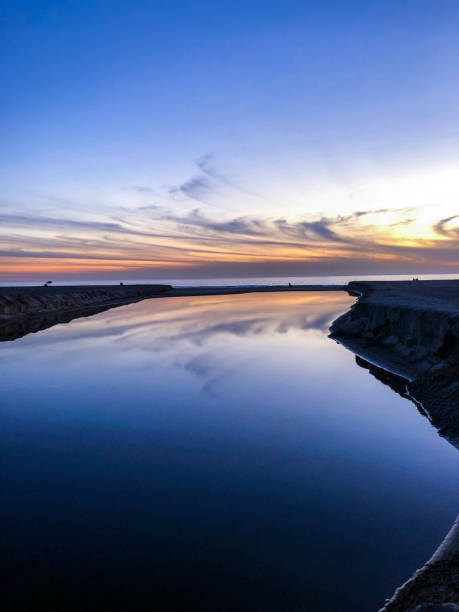 istock Moody sunset over Santa Monica beach with reflection on water 1091494916