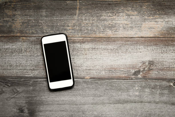 istock Mobile phone on wooden background 1091496670