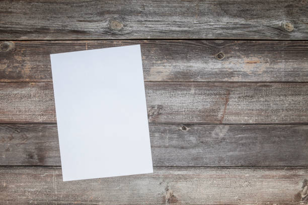 istock Blank a4 paper on wooden background 1091496724