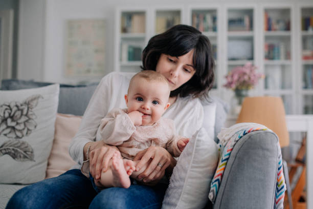 istock Mother cuddling with her baby daughter 1091497130