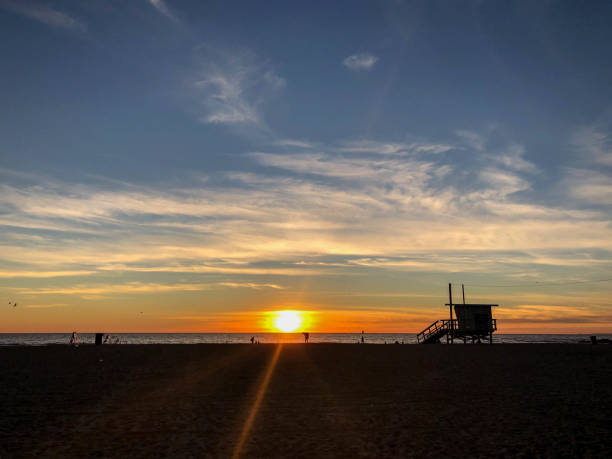 istock Sun sets over Venice Beach, CA with moody sky at Pride Lifeguard tower 1091498862