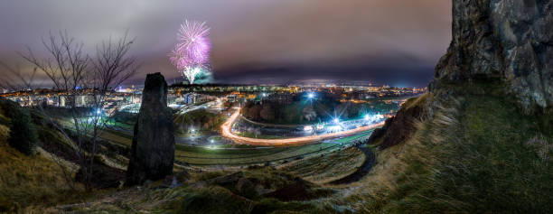 Huge Panorama of Edinburgh's Hogmanay Torchlight procession with fireworks in background Huge Panorama of Edinburgh's Hogmanay Torchlight procession with fireworks in background hogmanay photos stock pictures, royalty-free photos & images
