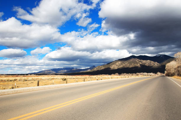 istock Taos, NM: Empty Road to Taos Mountains 1091499968