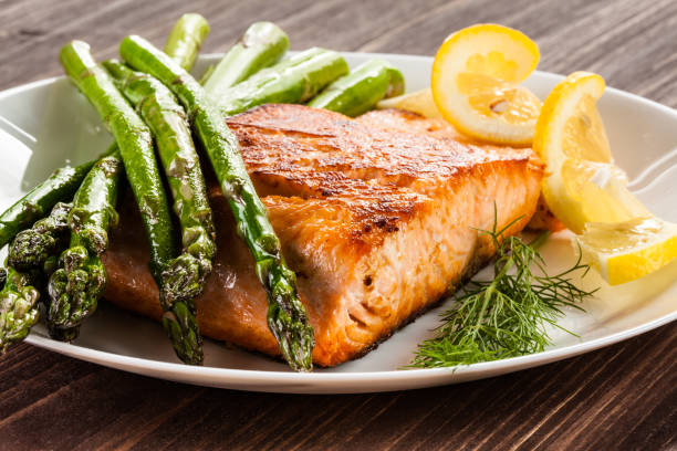 Grilled salmon with French fries and asparagus Grilled salmon with French fries and asparagus asparagus photos stock pictures, royalty-free photos & images