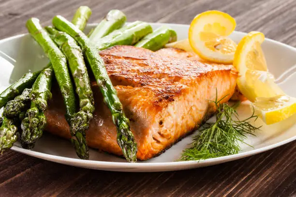 Photo of Grilled salmon with French fries and asparagus