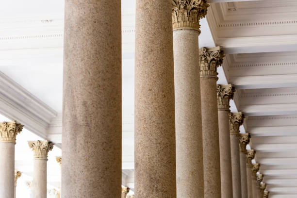 istock Colonnade, row of classical stone columns, background with copy spaced 1091502086