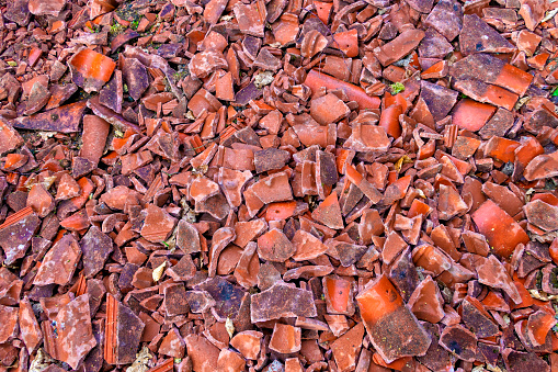 Broken rooftiles spread out on ground