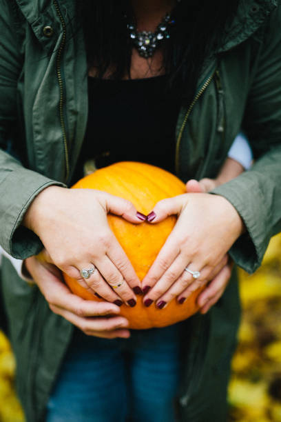 istock couple hugging holding a pumpkin as a baby 1091508002