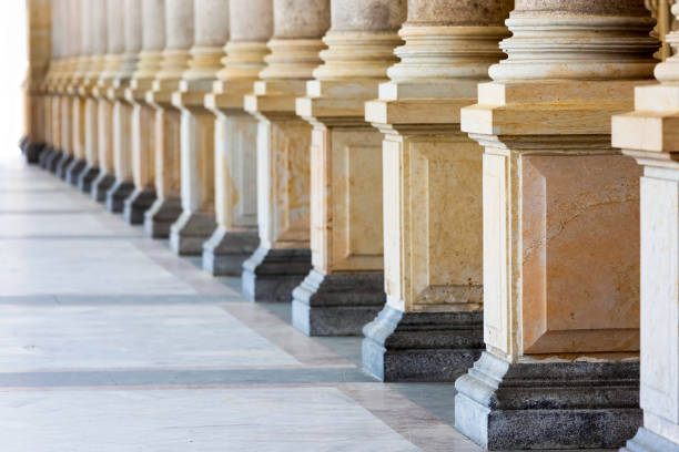 istock Colonnade, row of classical stone columns, background with copy spaced 1091510966