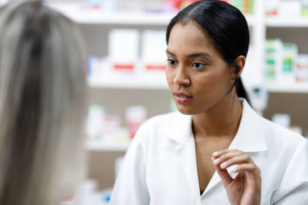 istock Pharmacist explaining to the client how to use the medication 1091518874