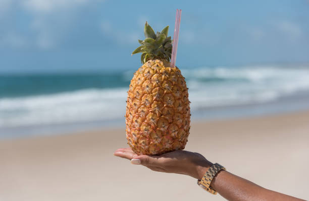 istock Female hand holding a pineapple cocktail 1091524162