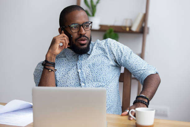 istock Busy black worker talking on mobile phone 1091526890